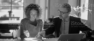 man and woman signing papers