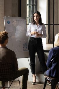 woman at whiteboard in meeting